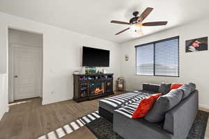 Living room featuring ceiling fan and hardwood / wood-style floors