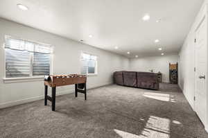 Game room with carpet floors and a textured ceiling