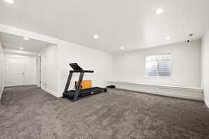 Exercise room featuring dark carpet