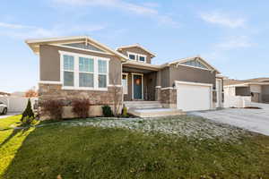 View of front of home with a front yard and a garage