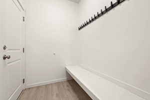 Mudroom with wood-type flooring