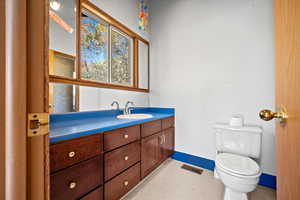 Bathroom featuring vanity and toilet