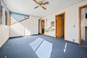 Interior space with carpet flooring and ceiling fan