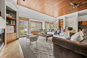 Living room featuring ceiling fan, light hardwood / wood-style floors, wood ceiling, and vaulted ceiling