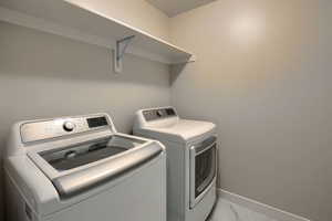 Laundry room with washing machine and clothes dryer