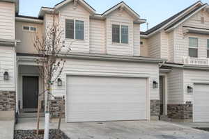 Townhome / multi-family property featuring a garage