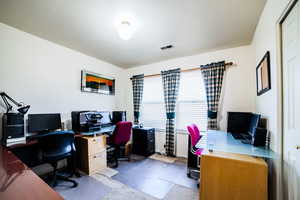 Office space featuring a textured ceiling