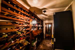 Wine area with a textured ceiling