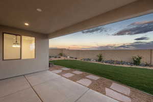 Patio terrace at dusk with a yard