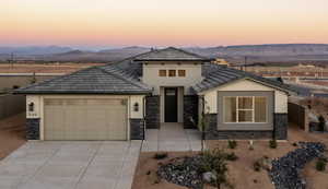 View of front of property with a mountain view and a garage