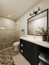 Bathroom featuring toilet, vanity, and walk in shower*Rendering