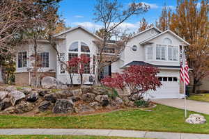 View of front of home featuring a garage and a front yard