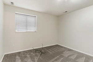 Unfurnished room with carpet