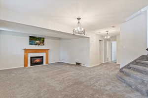 Carpeted living room with a tiled fireplace