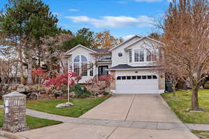 View of front of house featuring a garage and a front yard