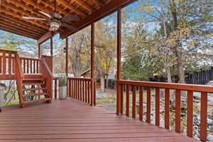 Wooden terrace featuring ceiling fan