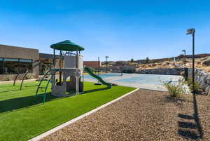 View of playground featuring a yard