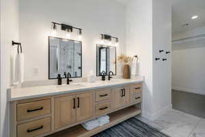 Bathroom featuring vanity and a shower with shower door