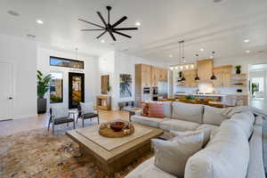 Living room featuring ceiling fan and light wood-type flooring