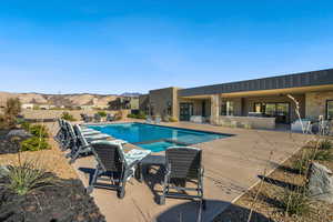 View of pool with a mountain view, an in ground hot tub, and a patio area