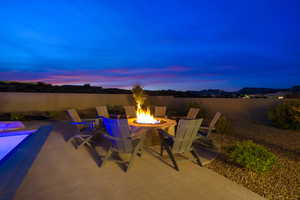 Patio terrace at dusk featuring an outdoor fire pit