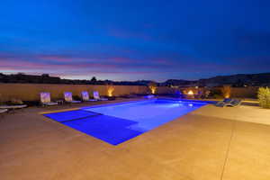 Pool at dusk with a patio