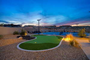 Yard at dusk featuring tennis court