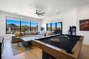 Game room featuring pool table, light wood-type flooring, and a wealth of natural light