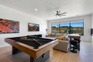 Playroom featuring light hardwood / wood-style floors, ceiling fan, and billiards