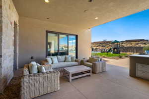 View of patio featuring outdoor lounge area and a playground