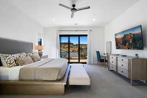 Carpeted bedroom featuring access to outside and ceiling fan