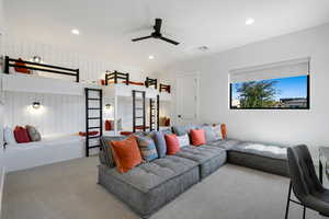 Carpeted living room featuring ceiling fan