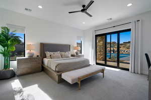 Carpeted bedroom featuring ceiling fan and access to exterior