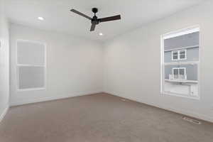 Carpeted empty room with ceiling fan