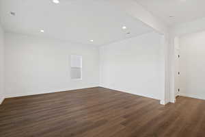 Spare room featuring dark wood-type flooring