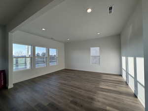 Empty room with dark wood-type flooring