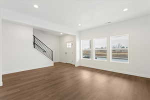 Unfurnished living room with dark hardwood / wood-style flooring