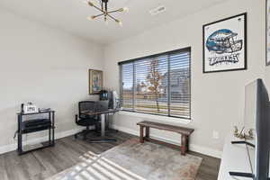 Office featuring hardwood / wood-style flooring and a chandelier