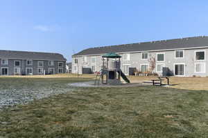 View of play area with a yard