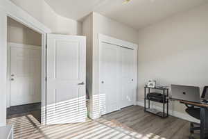 Home office with hardwood / wood-style flooring