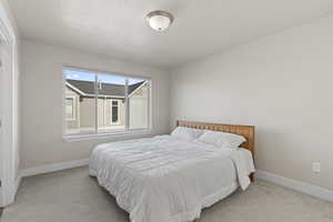 Carpeted bedroom with a textured ceiling
