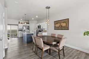Dining room with sink, a textured ceiling, and hardwood / wood-style flooring