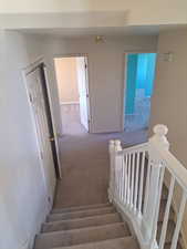 Staircase featuring carpet floors, laundry area and 3 bedrooms, 1 bathroom.