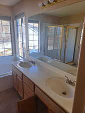 Bathroom with double sink vanity, large tub and walk in shower