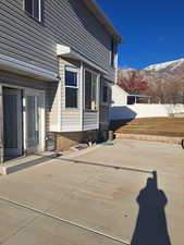 View of back of home featuring a mountain view and a patio