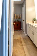 Bathroom featuring a skylight and vanity