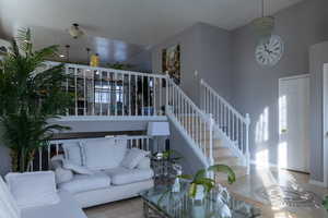 Tiled living room featuring a notable chandelier