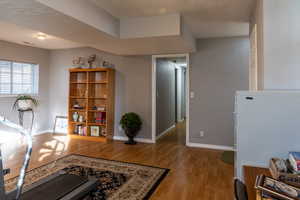 Interior space with a textured ceiling and light wood-type flooring