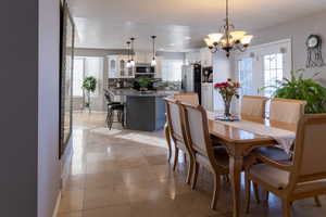 Dining space featuring a chandelier and light tile patterned floors