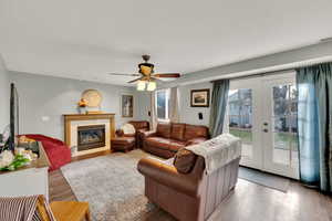 Living room featuring ceiling fan, hardwood / wood-style floors, track lighting, and french doors